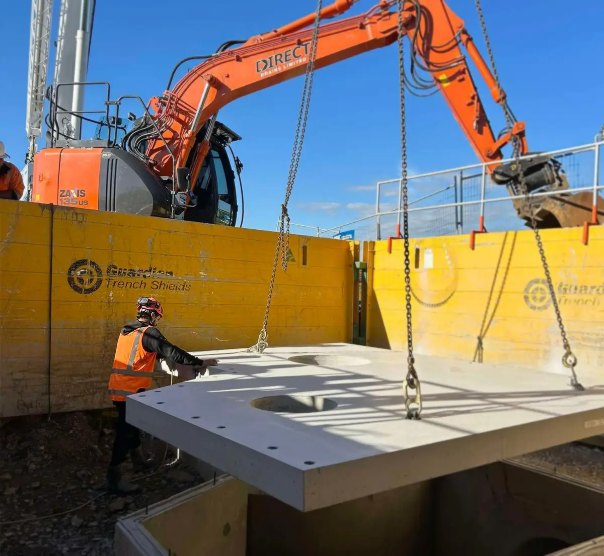 Concrete slabs with drainage being lowered into place on a Duttons site